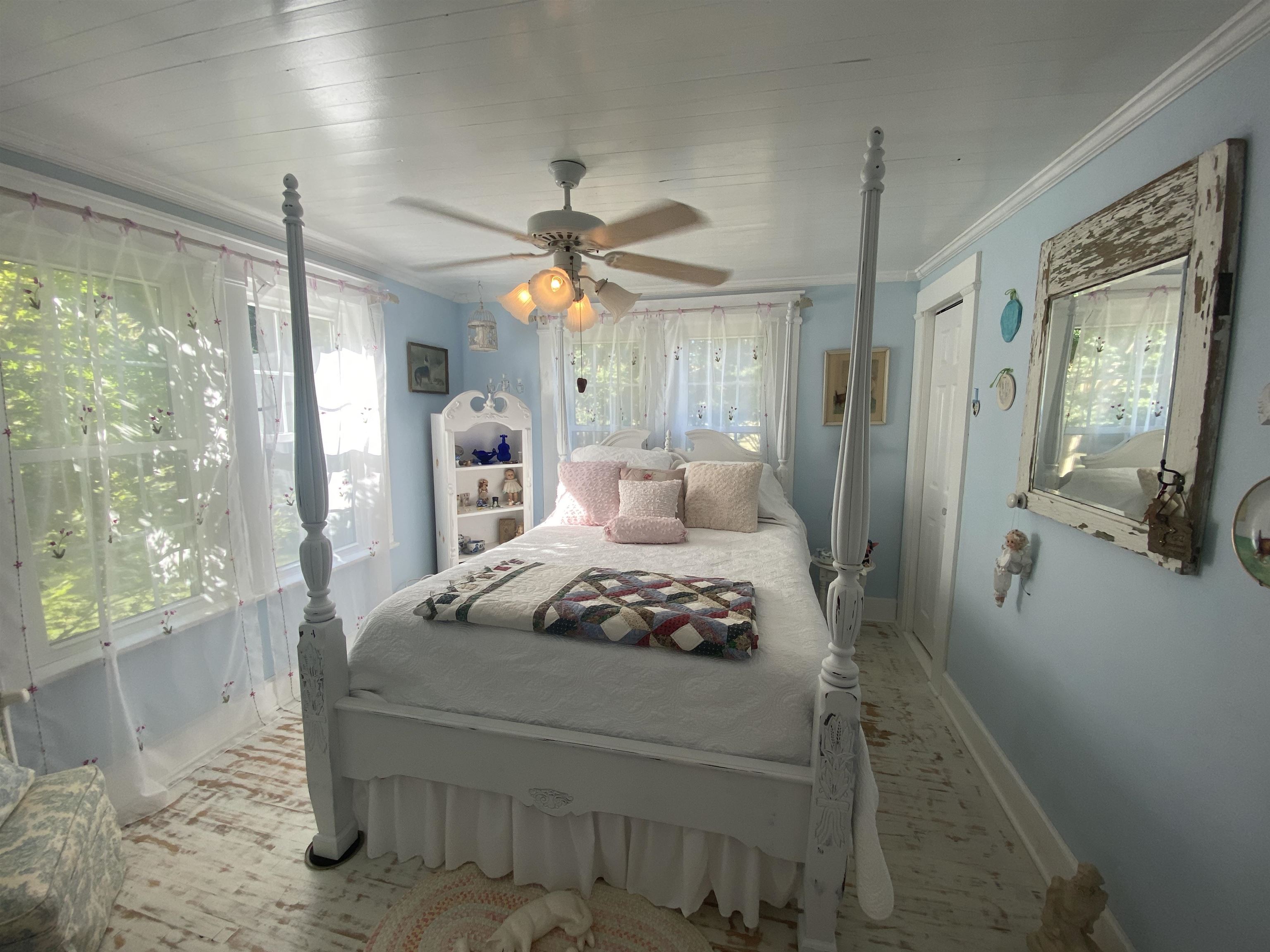90 Dickson Road Sardis, TN 38371 - Photo 15 of 25 a bedroom with a large bed and a chandelier