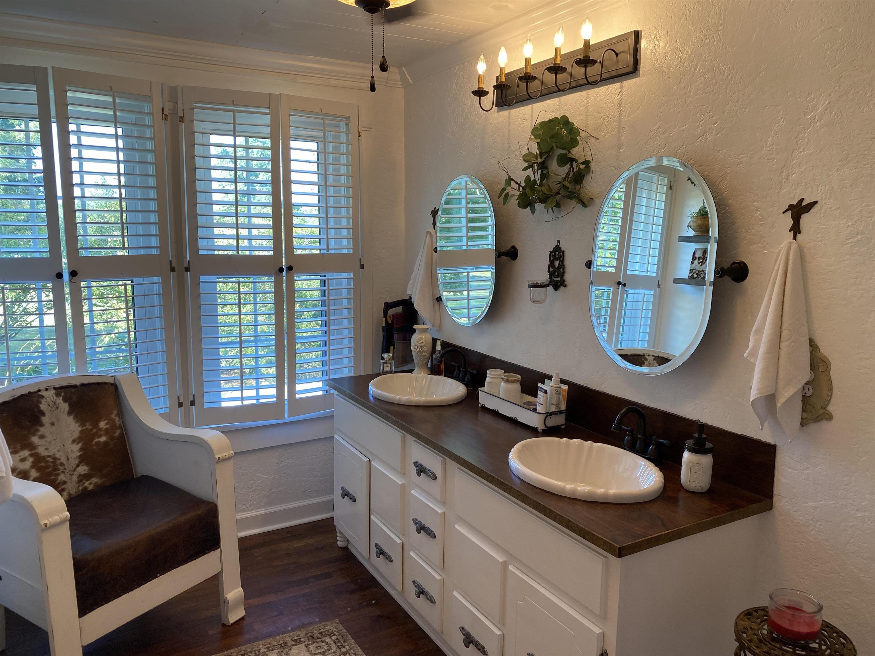 90 Dickson Road Sardis, TN 38371 - Photo 16 of 25 a bathroom with a granite countertop sink a mirror and window