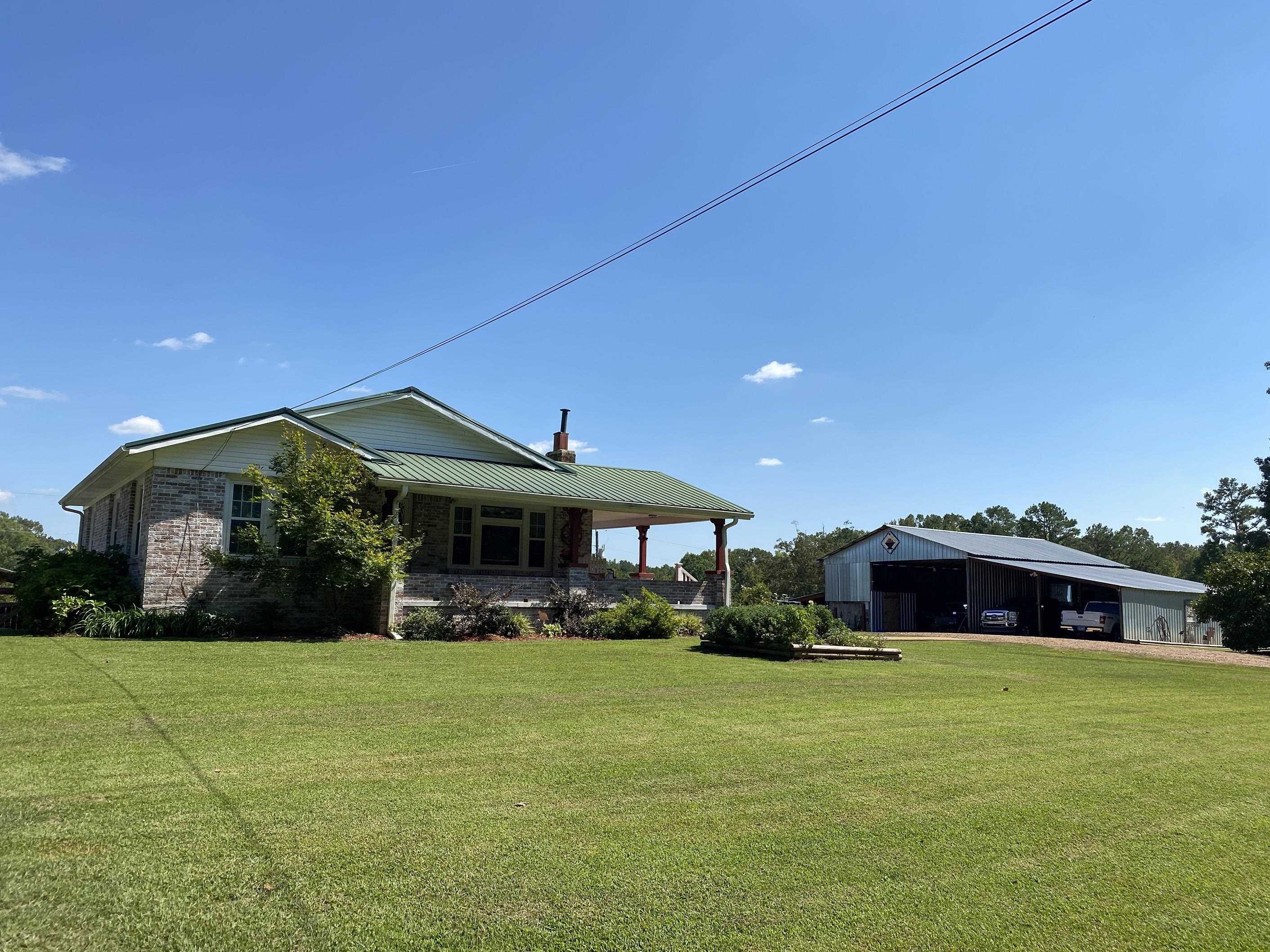90 Dickson Road Sardis, TN 38371 - Photo 3 of 25 a front view of a house with a yard