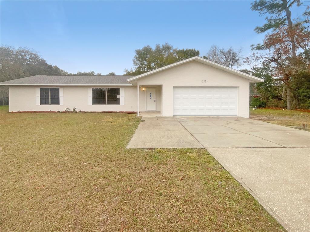 2121 Pine Road Ocala, FL 34472 - Photo 1 of 1 a view of a house with a yard and potted plants