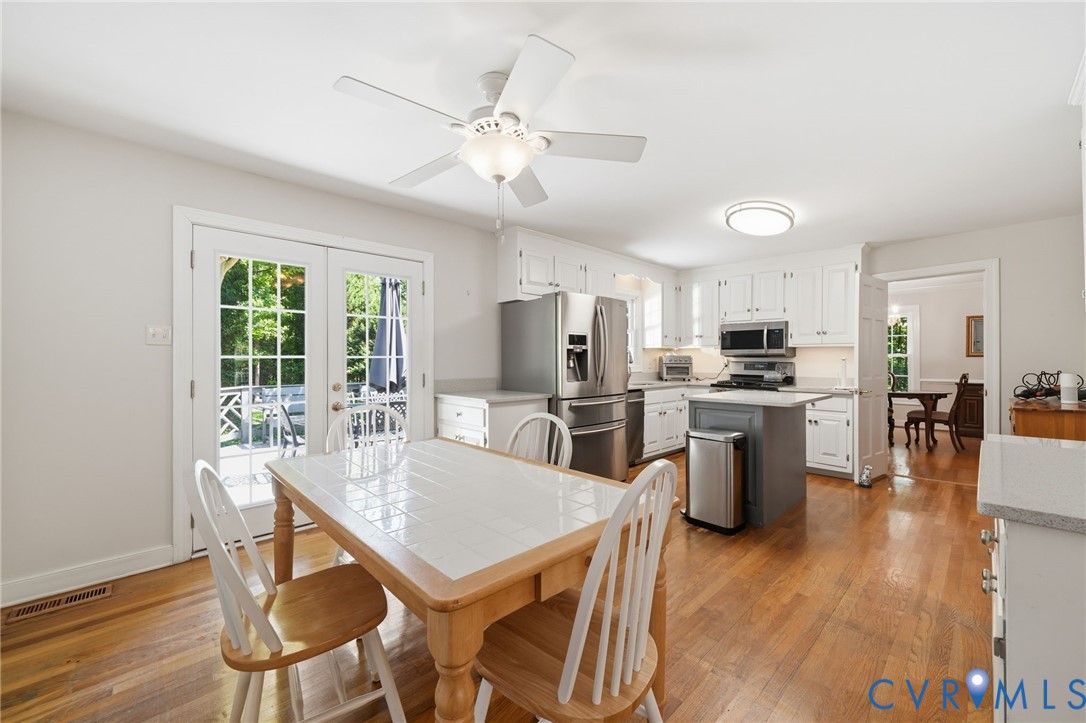 2101 Castlebridge Road Midlothian, VA 23113 - Photo 10 of 37 a view of a dining room with furniture a kitchen and chandelier