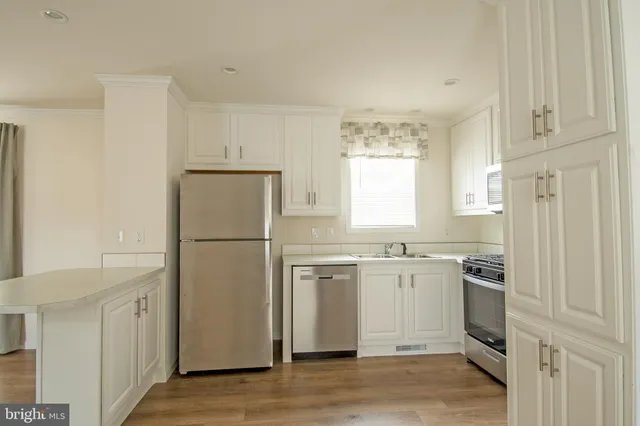 a kitchen with cabinets and stainless steel appliances