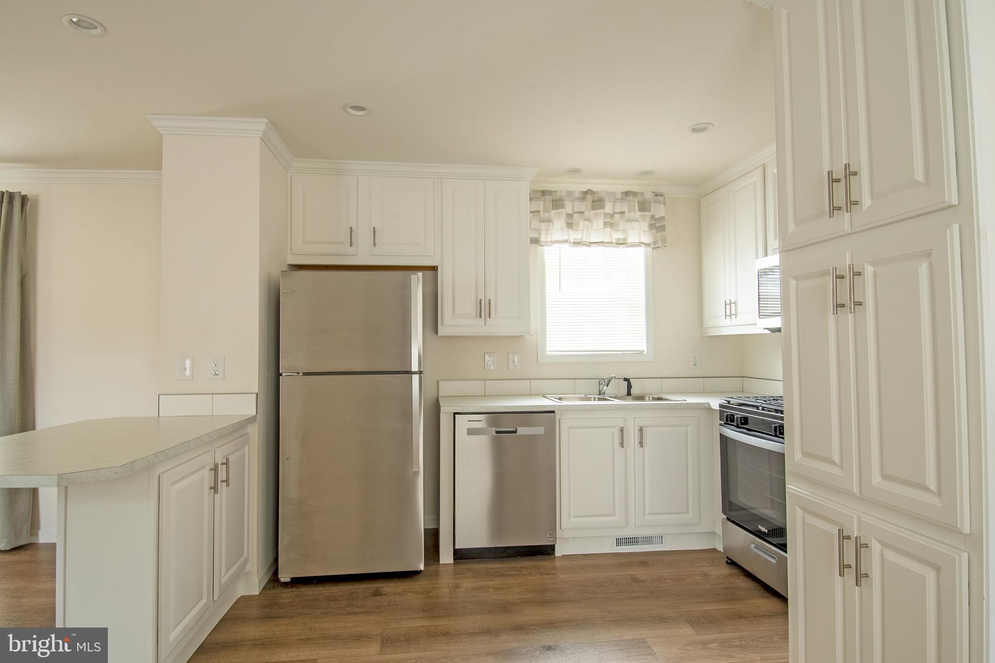 1679 South State Street, Unit A8 Dover, DE 19901 - Photo 13 of 19 a kitchen with cabinets and stainless steel appliances