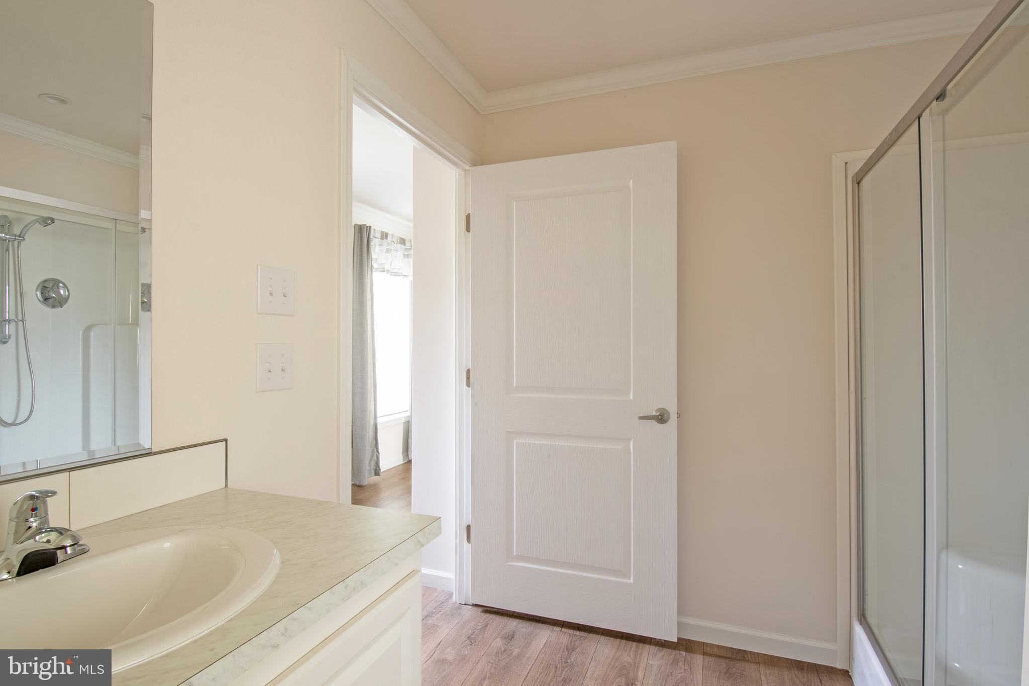 1679 South State Street, Unit A8 Dover, DE 19901 - Photo 16 of 19 a bathroom with a sink and a large mirror