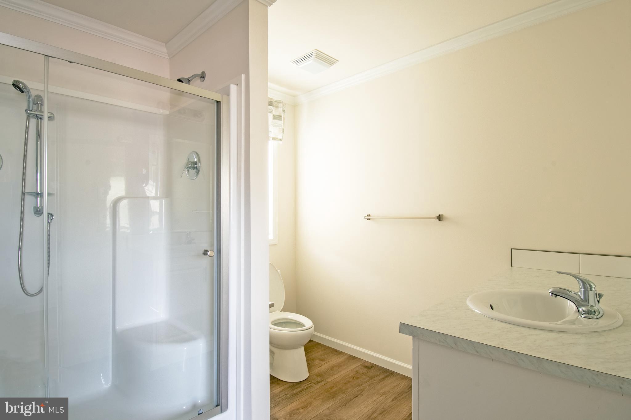 1679 South State Street, Unit A8 Dover, DE 19901 - Photo 17 of 19 a bathroom with a granite countertop sink toilet and shower