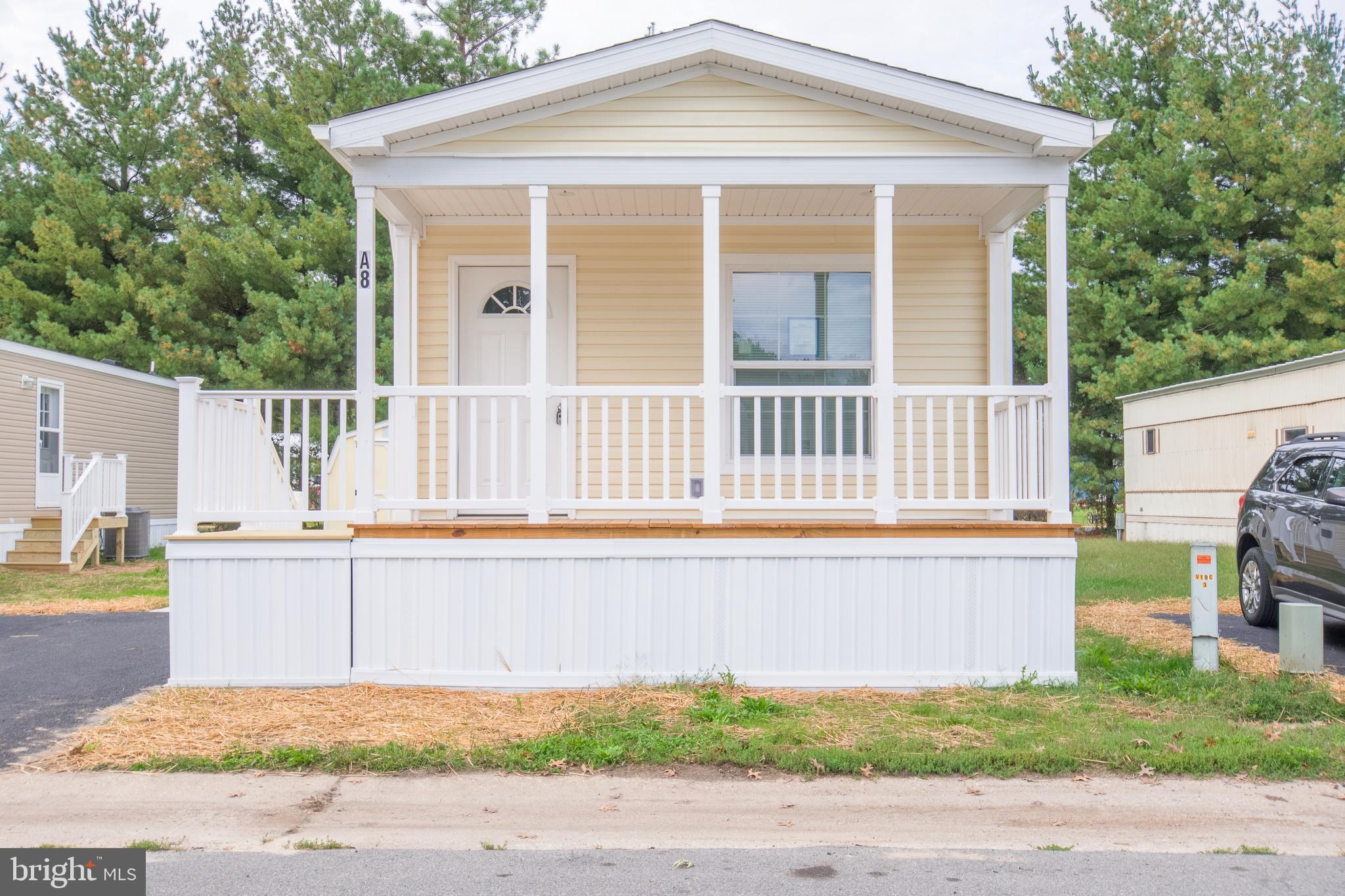1679 South State Street, Unit A8 Dover, DE 19901 - Photo 2 of 19 a front view of a house with a swimming pool