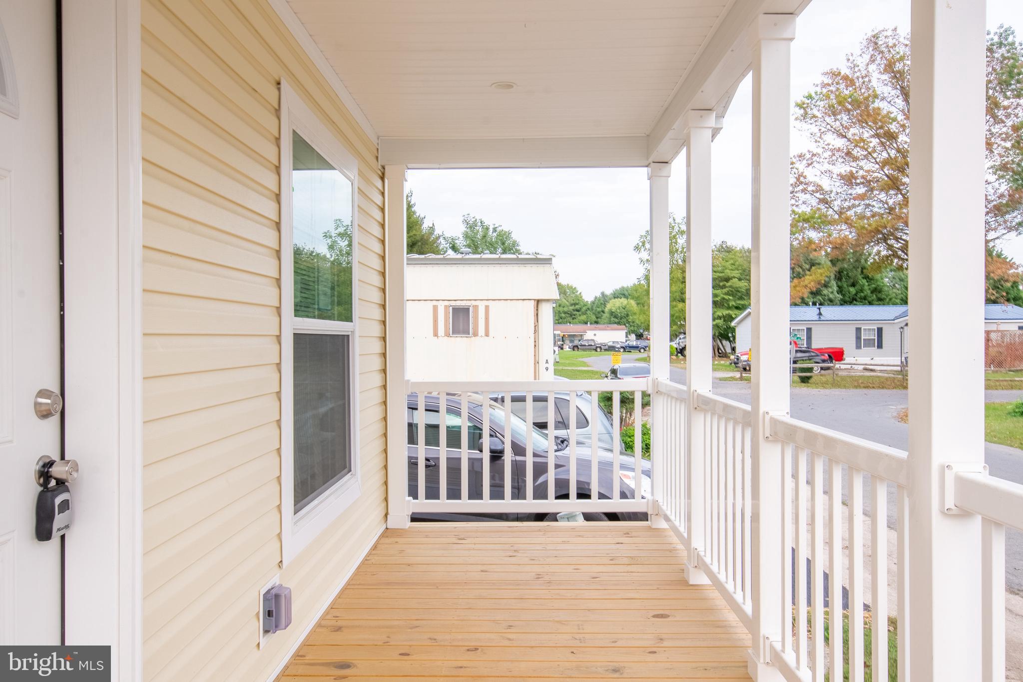 1679 South State Street, Unit A8 Dover, DE 19901 - Photo 4 of 19 a view of a balcony with wooden floor