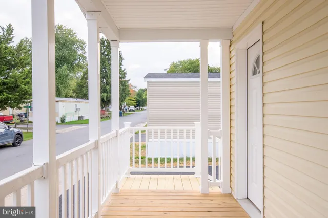 a view of a porch with wooden floor and outdoor space