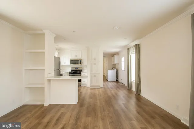 a view of a kitchen cabinets and wooden floor