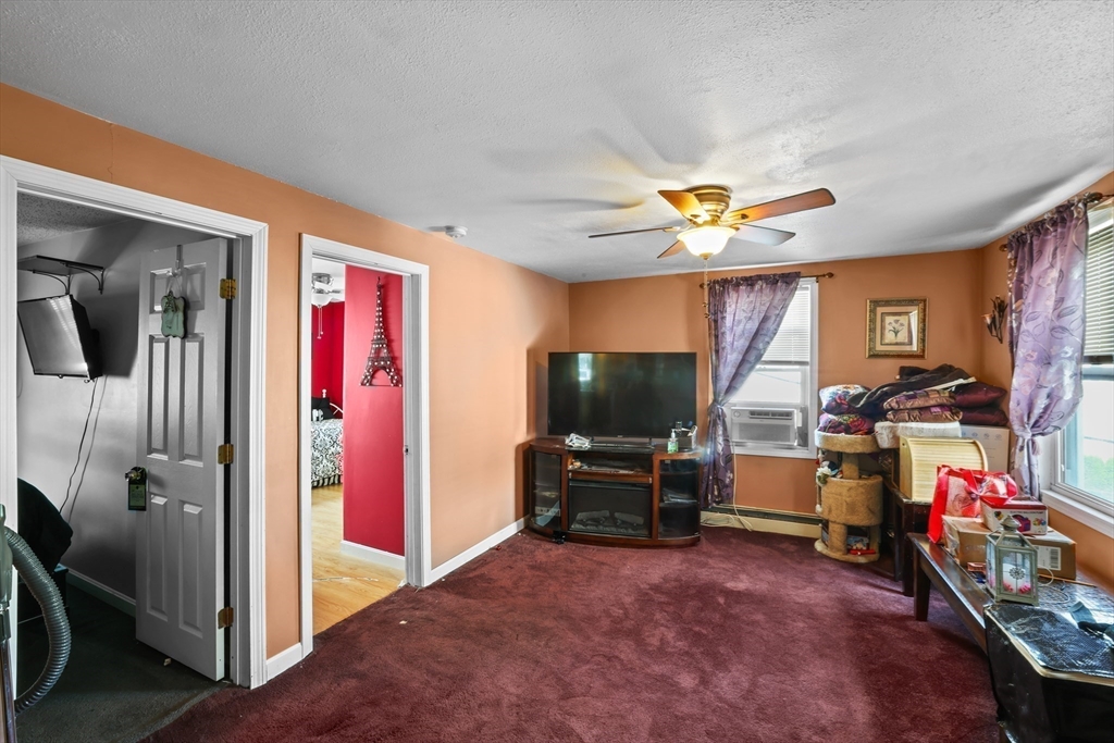 242 Washington Street Fall River, MA 02721 - Photo 14 of 23 a view of a livingroom with workspace and a ceiling fan