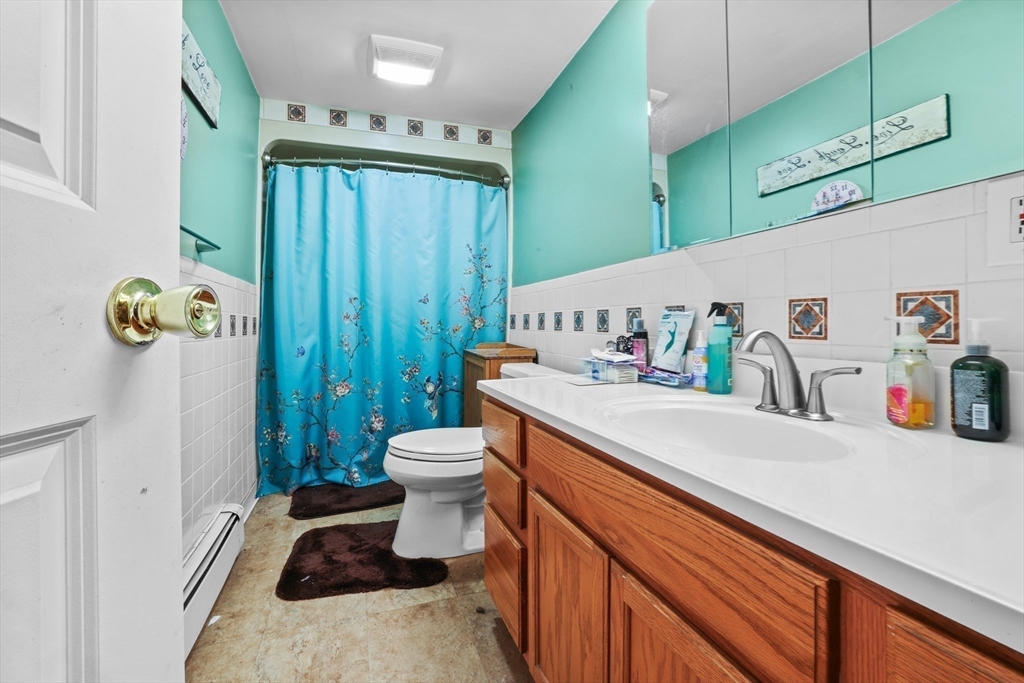 242 Washington Street Fall River, MA 02721 - Photo 16 of 23 a bathroom with a sink a toilet and a shower