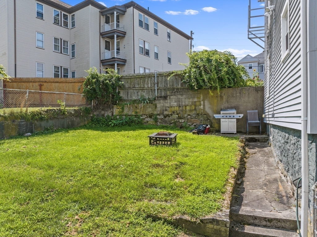242 Washington Street Fall River, MA 02721 - Photo 8 of 23 a backyard of a house with outdoor seating