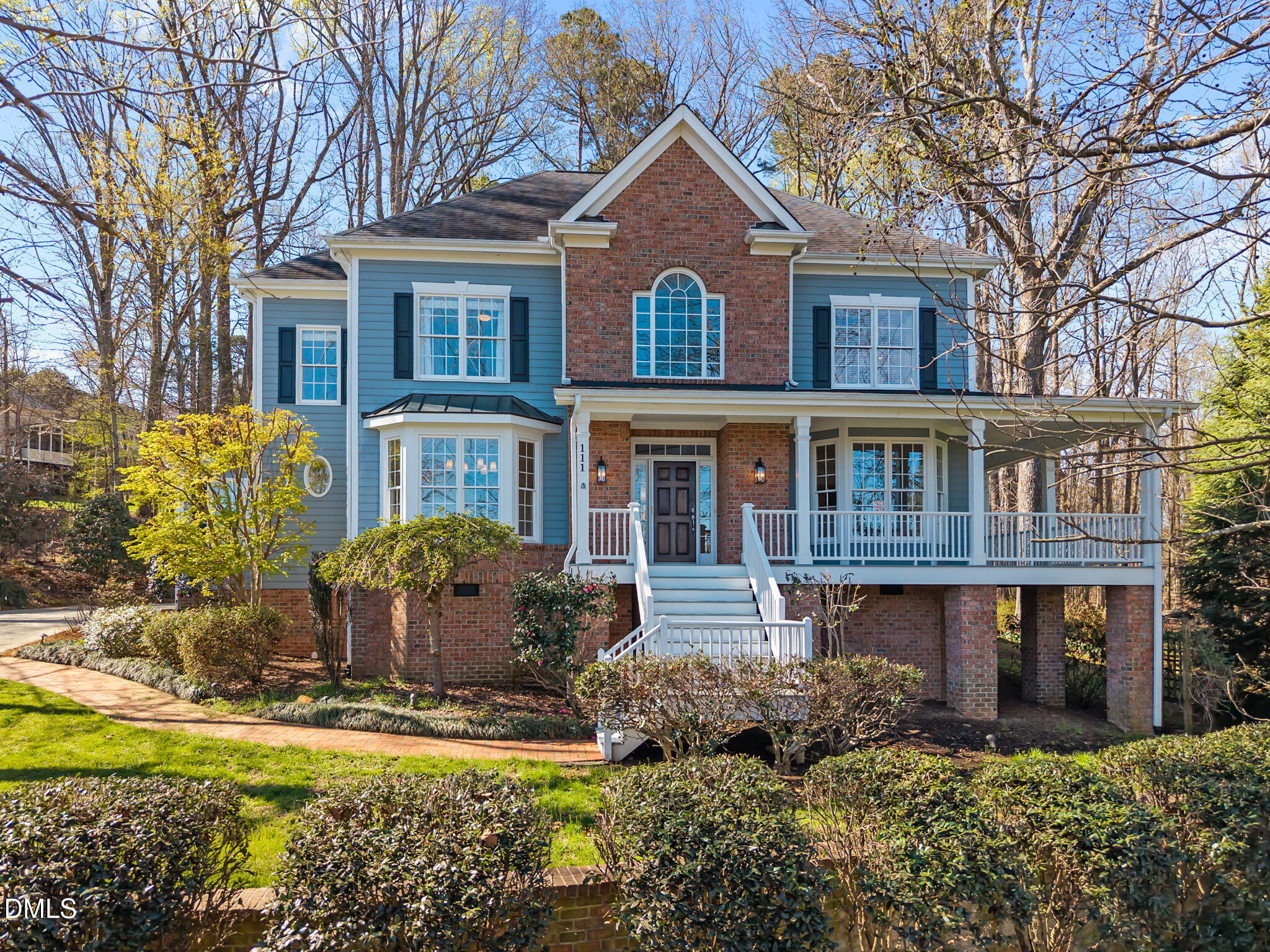 a front view of a house with a yard and lake view