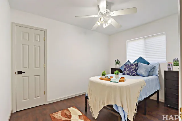 a bedroom with a bed and a chandelier