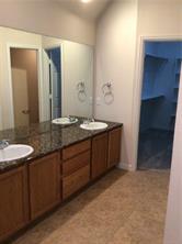 14812 Avery Ranch Boulevard, Unit 64 Austin, TX 78717 - Photo 15 of 26 a bathroom with a granite countertop sink and a mirror