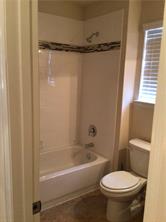 14812 Avery Ranch Boulevard, Unit 64 Austin, TX 78717 - Photo 20 of 26 a white toilet sitting next to a bath tub
