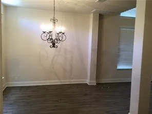 a room with a window and a chandelier