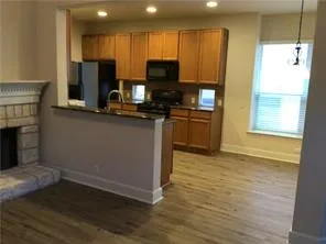 a kitchen with stainless steel appliances granite countertop a stove top oven a sink and a microwave