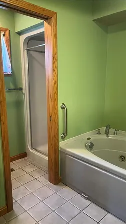 a bathroom with a tub sink and shower