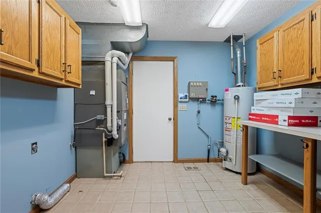 an empty room with window and ceiling fan