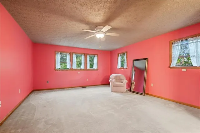 a view of a livingroom with a ceiling fan and window