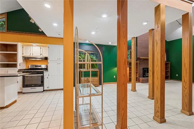 a kitchen with stainless steel appliances kitchen island granite countertop a refrigerator and a sink