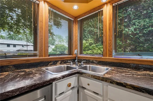 a kitchen with a sink and a large window