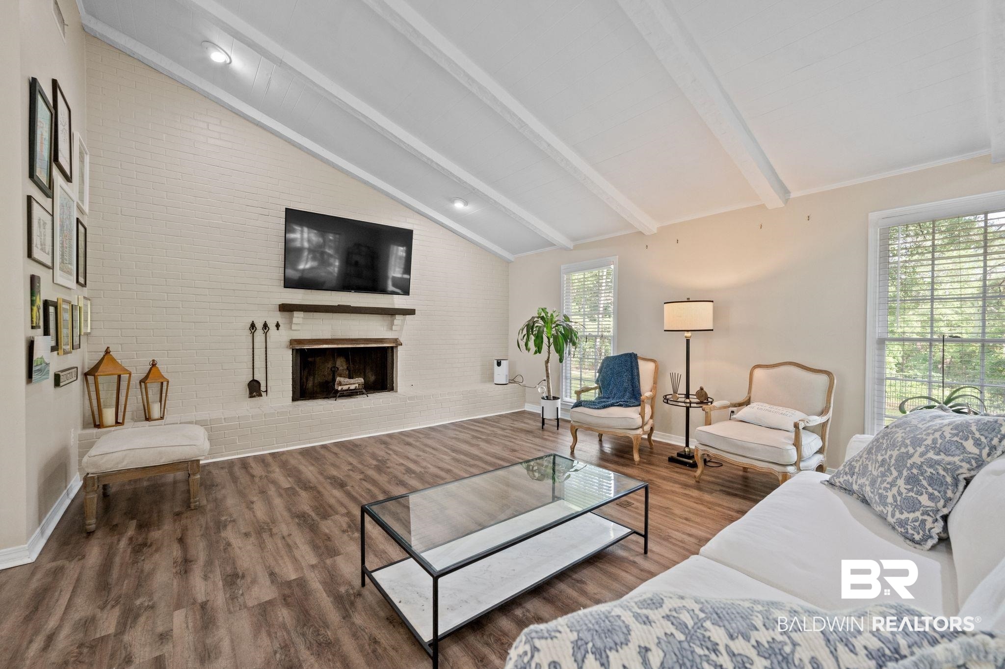110 Ferncliff Circle Daphne, AL 36526 - Photo 12 of 40 Living area featuring wood finished floors, a fireplace, brick wall, and baseboards