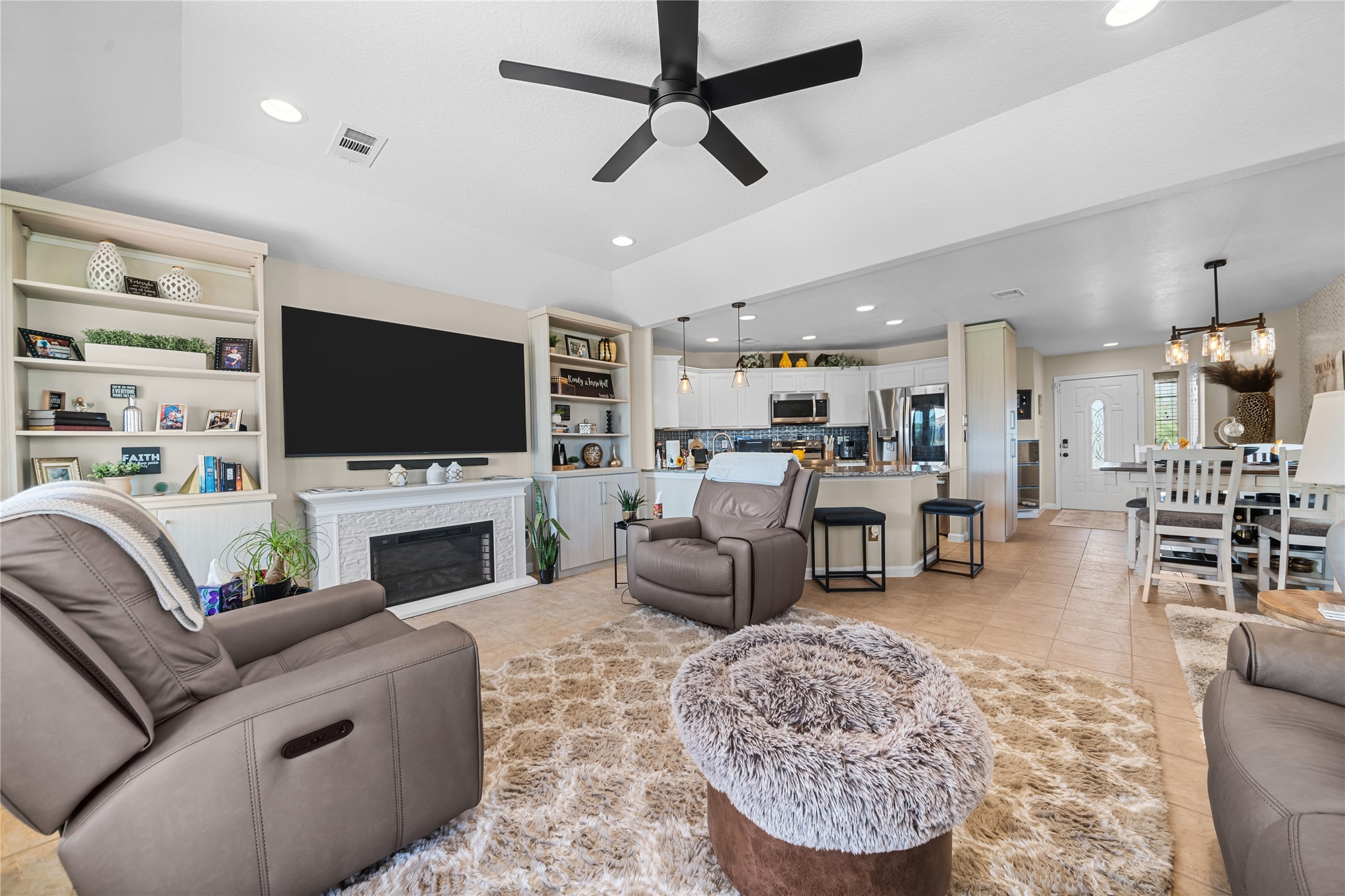 615 28th Street Dickinson, TX 77539 - Photo 12 of 34 a living room with furniture a flat screen tv and a fireplace