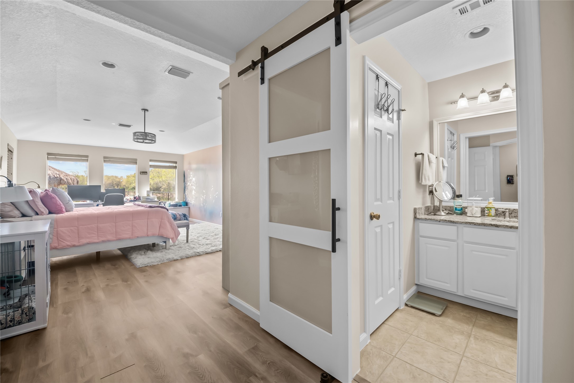 615 28th Street Dickinson, TX 77539 - Photo 19 of 34 a bedroom with a bed and a view of bathroom