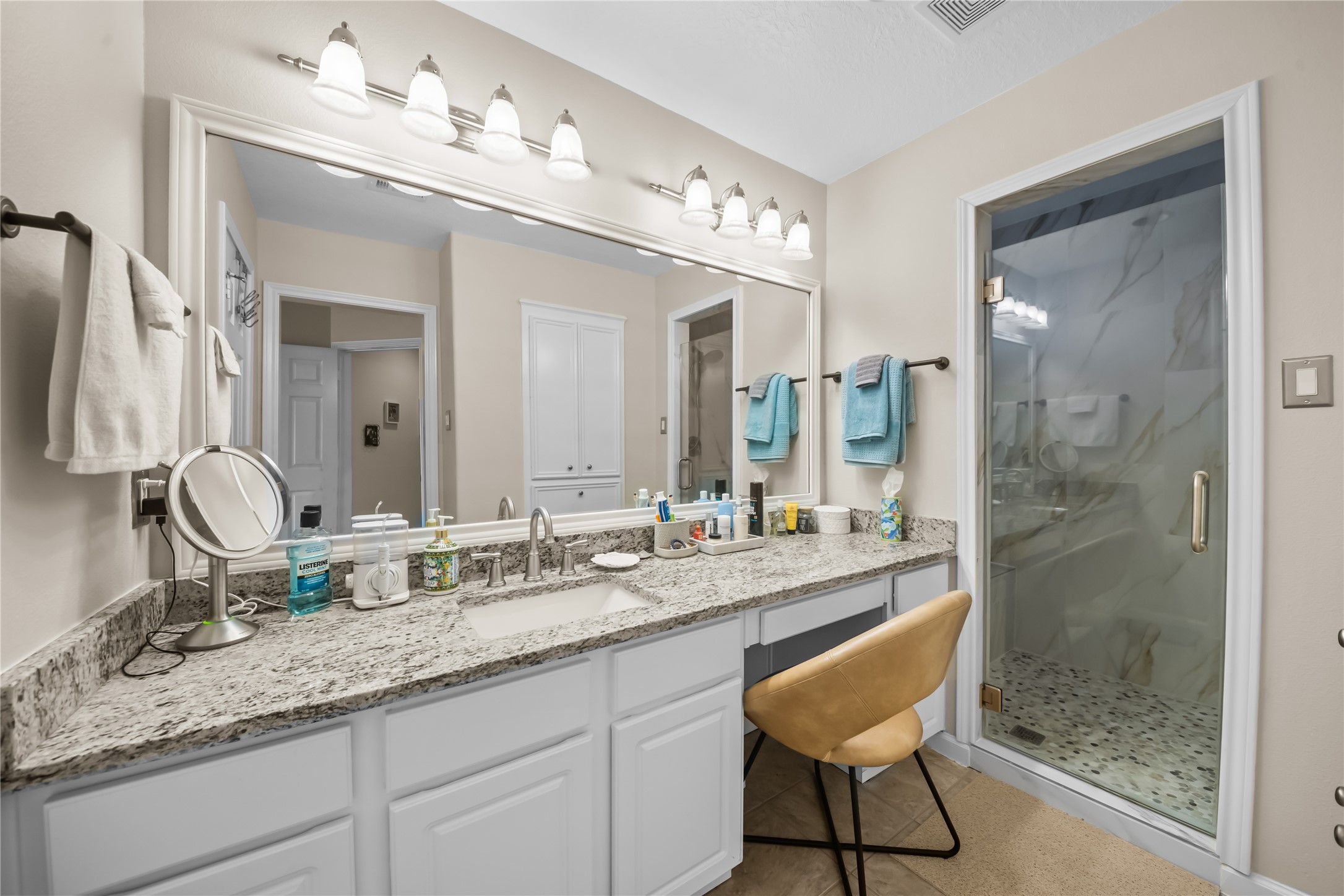 615 28th Street Dickinson, TX 77539 - Photo 20 of 34 a bathroom with a granite countertop sink a mirror and a shower