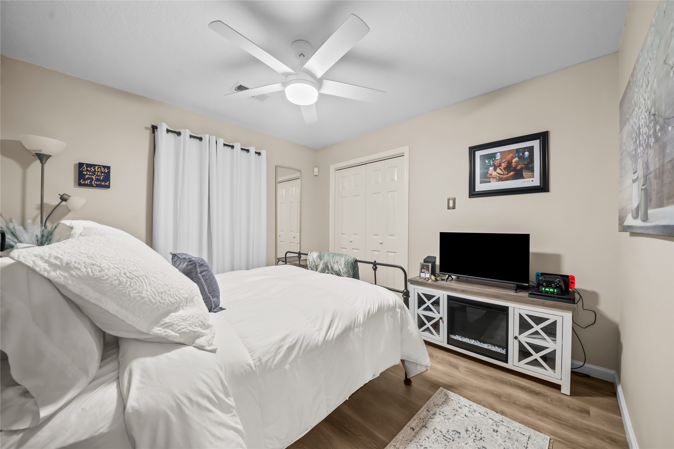 615 28th Street Dickinson, TX 77539 - Photo 22 of 34 a bedroom with a bed and a flat screen tv
