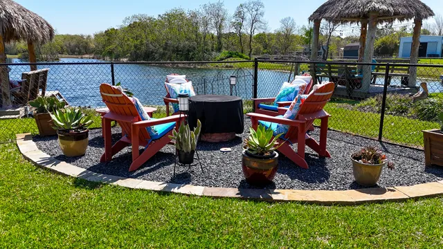a view of a lake with a deck and dining space