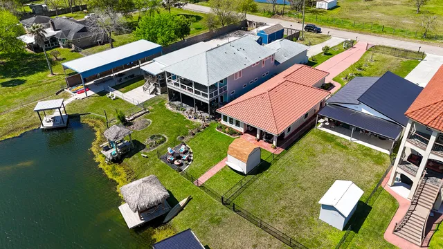 an aerial view of a house with a garden and swimming pool