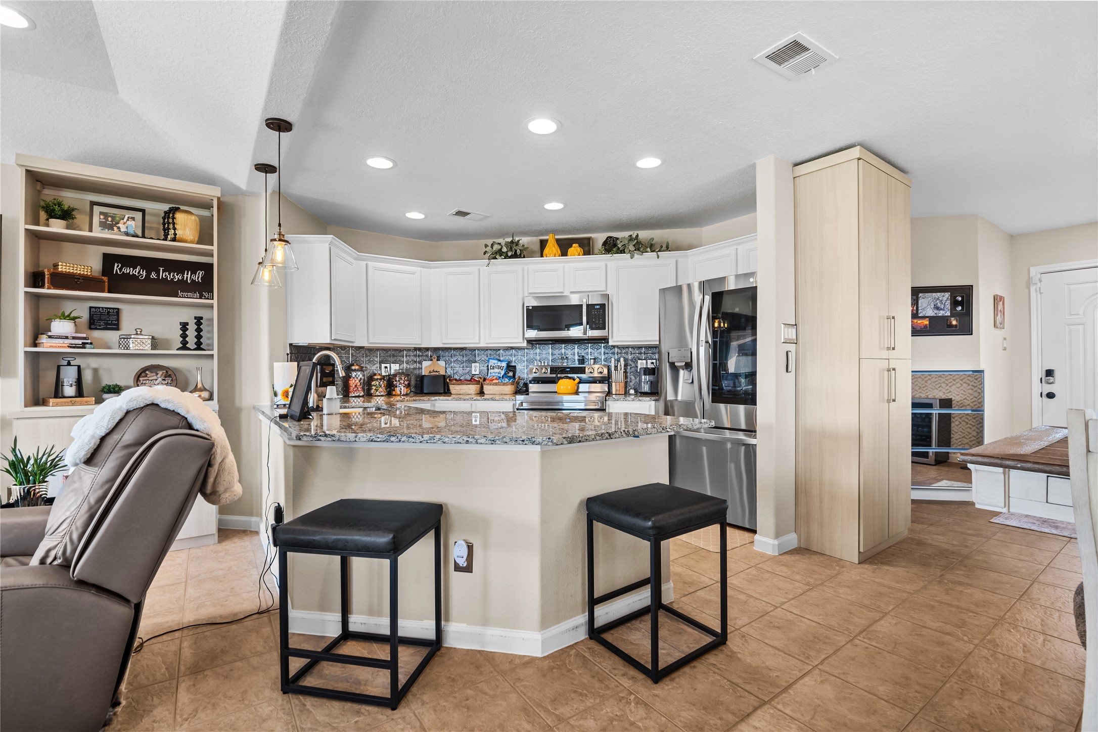 615 28th Street Dickinson, TX 77539 - Photo 10 of 34 a kitchen with stainless steel appliances granite countertop a refrigerator and a dining table