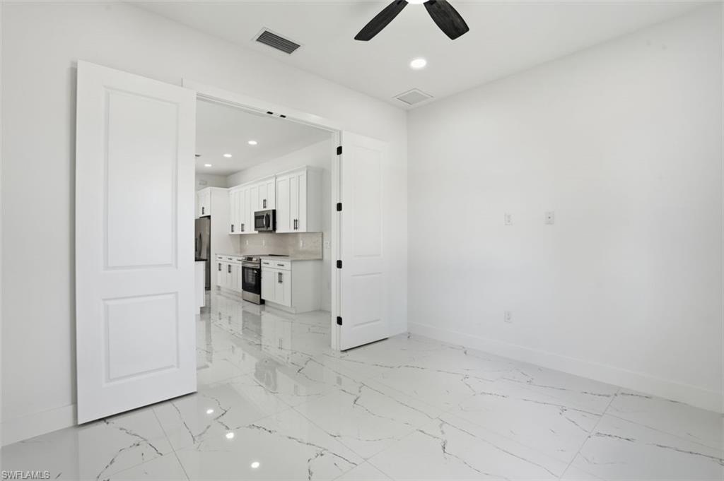 2930 20th Street Southwest Lehigh Acres, FL 33976 - Photo 20 of 43 an empty room with white cabinet and windows