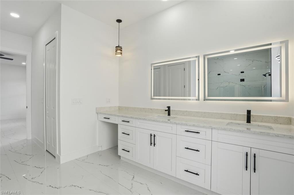 2930 20th Street Southwest Lehigh Acres, FL 33976 - Photo 22 of 43 a bathroom with a granite countertop sink mirror and double