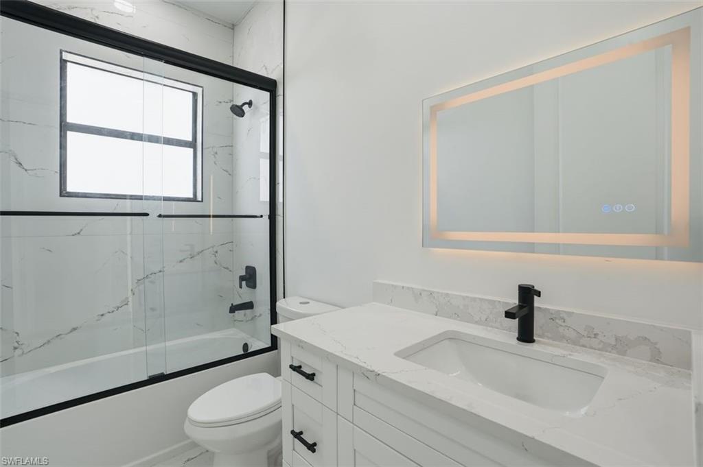 2930 20th Street Southwest Lehigh Acres, FL 33976 - Photo 25 of 43 a bathroom with a sink a toilet and shower