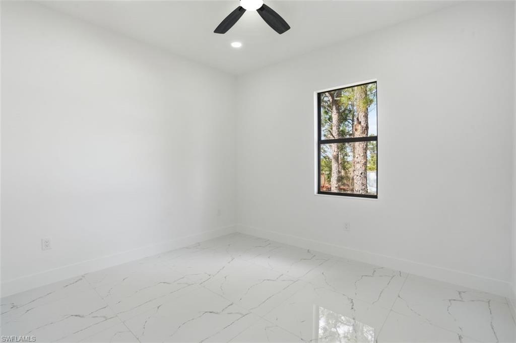 2930 20th Street Southwest Lehigh Acres, FL 33976 - Photo 26 of 43 an empty room with ceiling fan and window