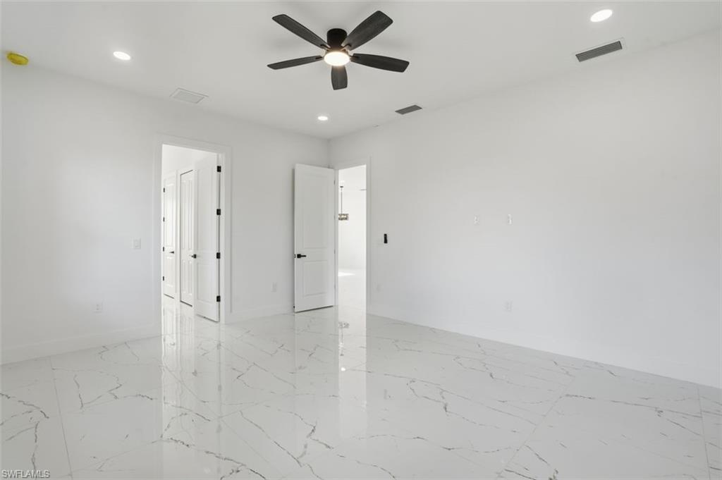 2930 20th Street Southwest Lehigh Acres, FL 33976 - Photo 32 of 43 an empty room with closet and a ceiling fan