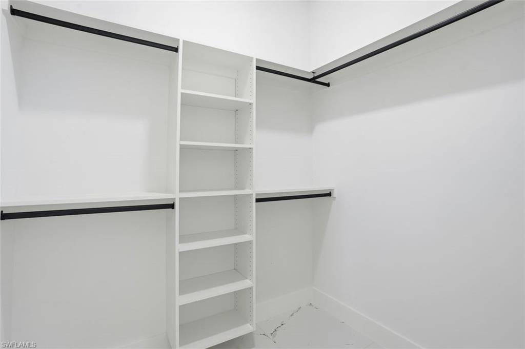 2930 20th Street Southwest Lehigh Acres, FL 33976 - Photo 34 of 43 a view of walk in closet with empty racks