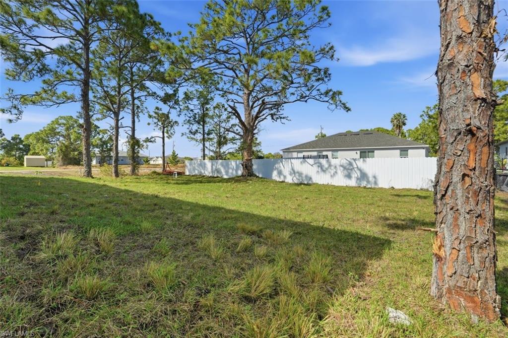 2930 20th Street Southwest Lehigh Acres, FL 33976 - Photo 40 of 43 a view of a yard with large trees