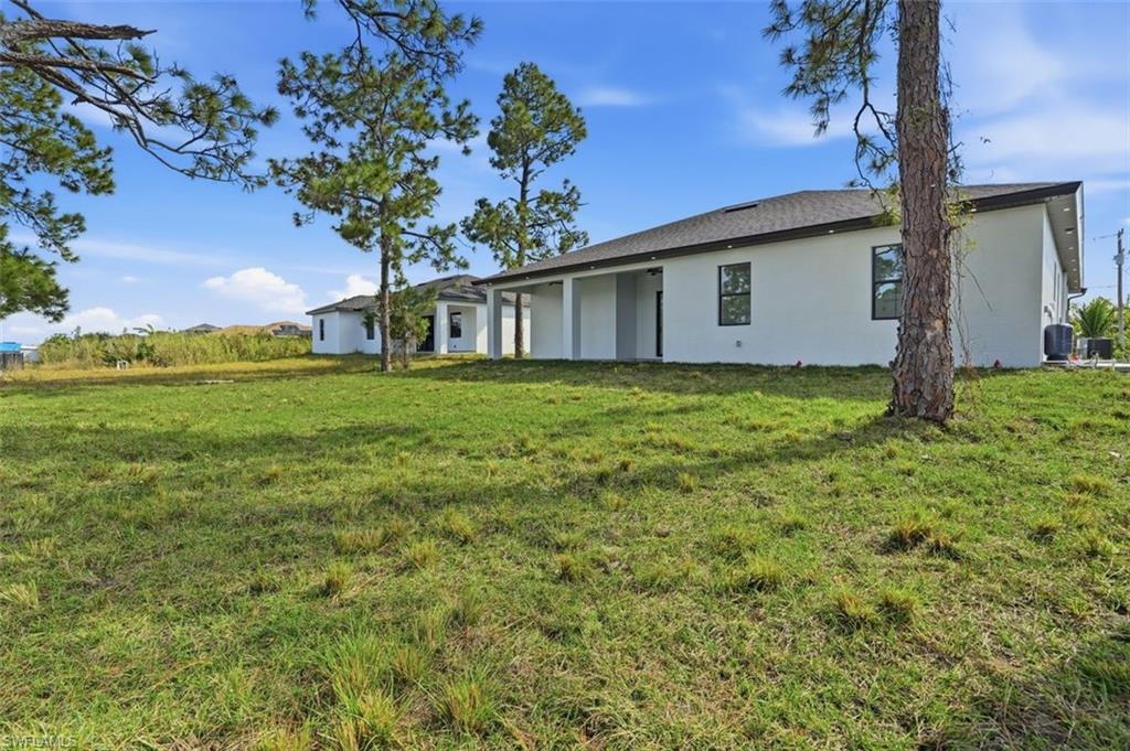 2930 20th Street Southwest Lehigh Acres, FL 33976 - Photo 42 of 43 a view of a house with a big yard