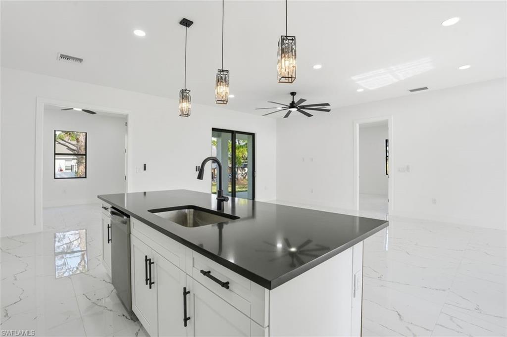2930 20th Street Southwest Lehigh Acres, FL 33976 - Photo 5 of 43 a kitchen with stainless steel appliances granite countertop a sink and a refrigerator