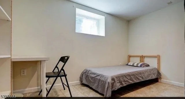 a bedroom with a bed and a chair