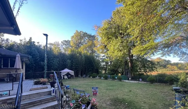a view of a wooden deck and a backyard
