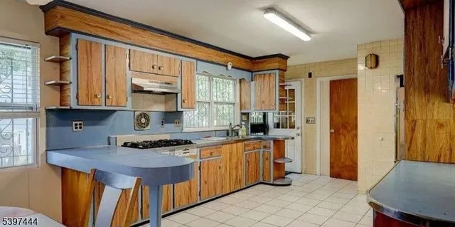 a kitchen with stainless steel appliances a stove a sink and a refrigerator