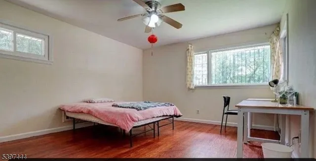 a bedroom with bed and a window