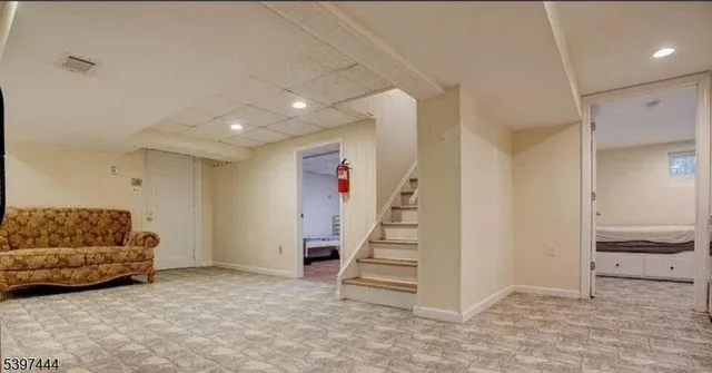 a living room with furniture and stairs