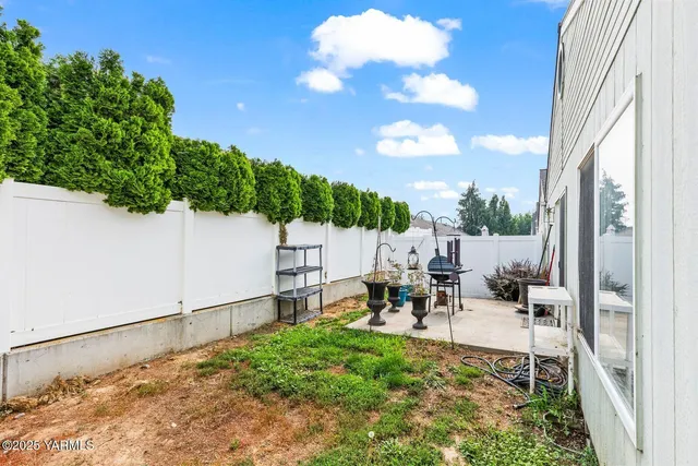 a view of a backyard with sitting area